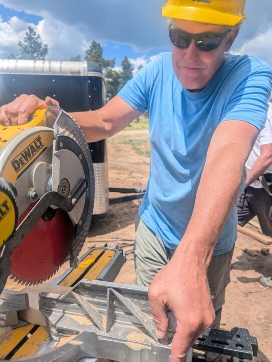 Volunteer Brian Reid using a saw. 